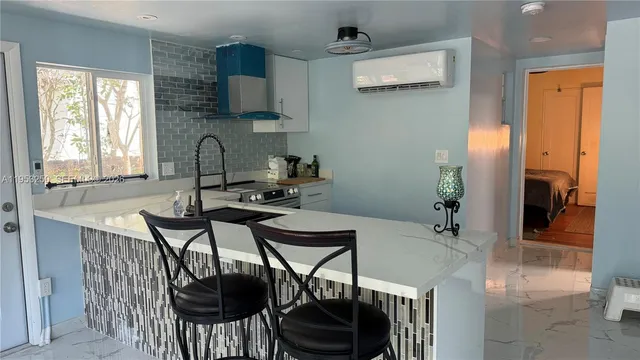 a view of a dining room with furniture and window