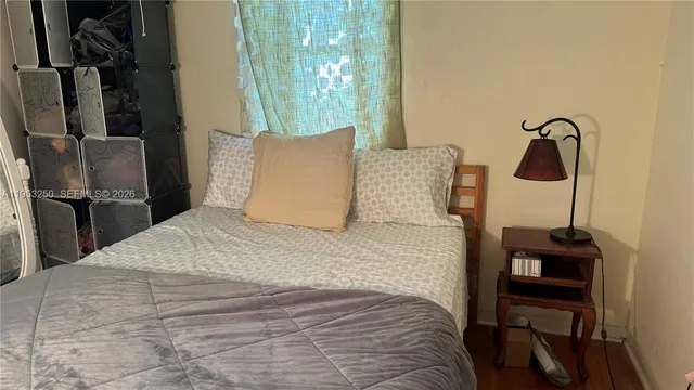 a bedroom with a bed and a mirror