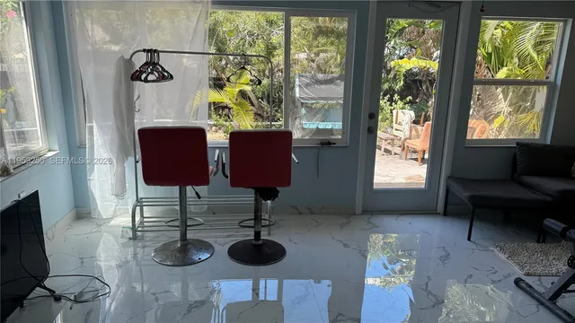 a living room with furniture and a floor to ceiling window