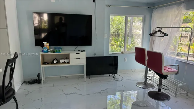 a room with furniture and a flat screen tv
