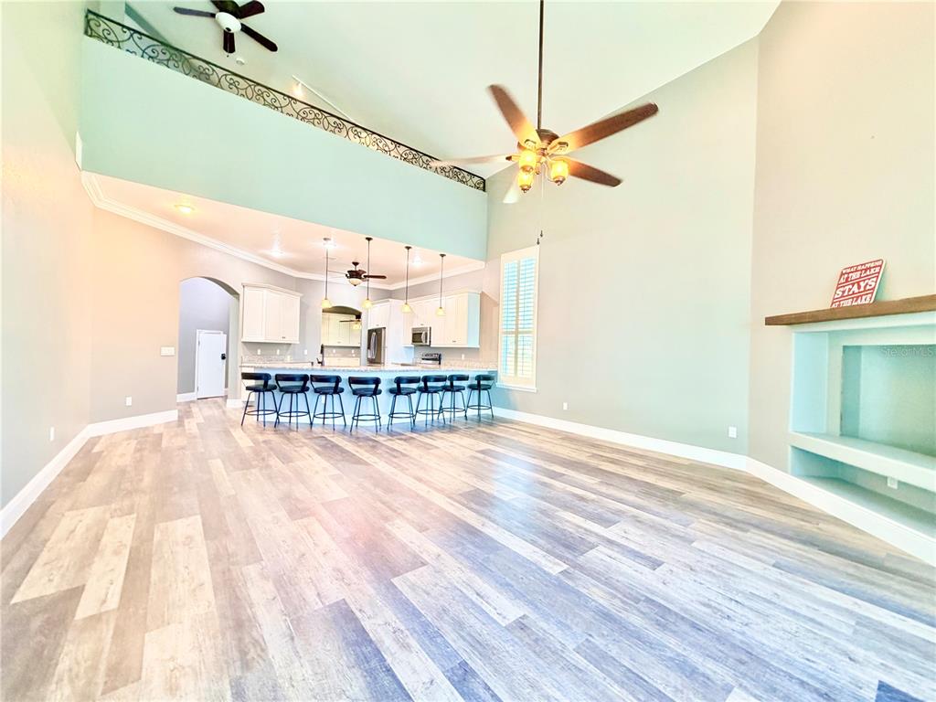 5243 West Lake Butler Road Windermere, FL 34786 - Photo 9 of 43 a view of a room with wooden floor and fan