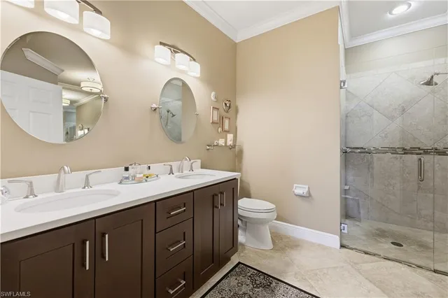 a bathroom with a toilet sink vanity and mirror