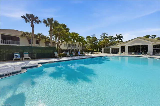 an aerial view of a residential apartment building with a yard