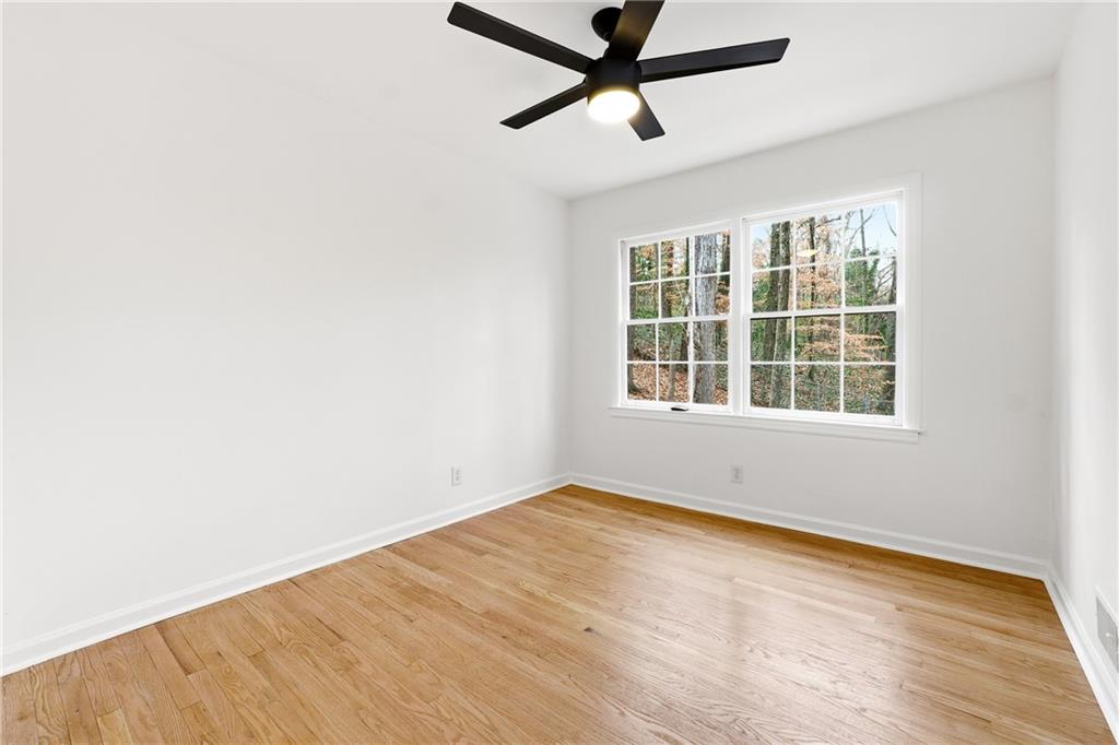 2520 Overlook Way Northeast Atlanta, GA 30345 - Photo 27 of 31 an empty room with wooden floor and windows