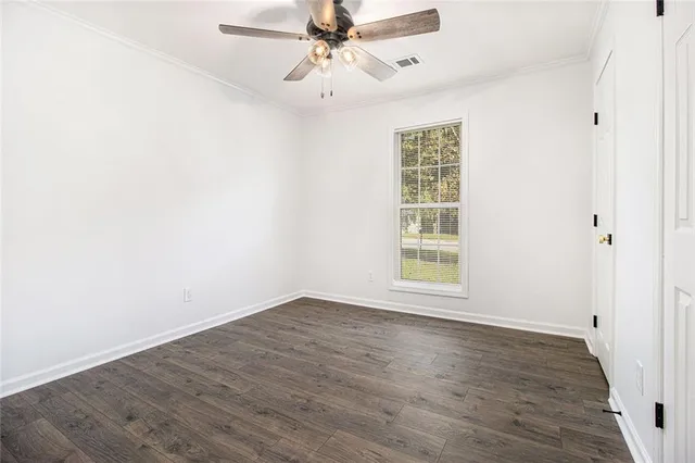 wooden floor in an empty room with a window