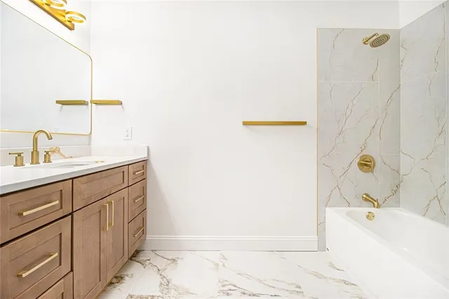 a bathroom with a sink a bathtub and a shower