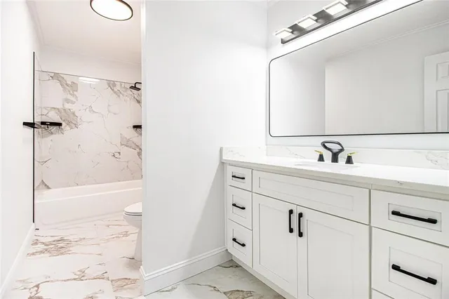 a bathroom with a bathtub and a sink