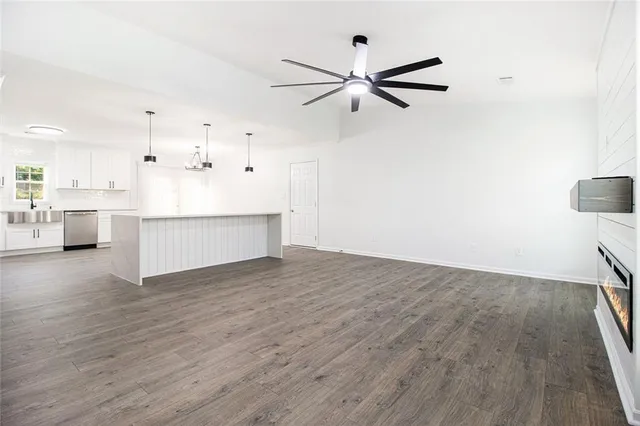 a view of a kitchen with wooden floor and a sink