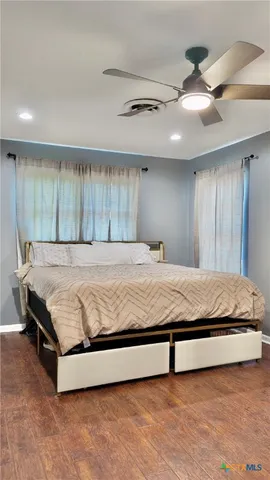 a bedroom with a large bed and a chandelier