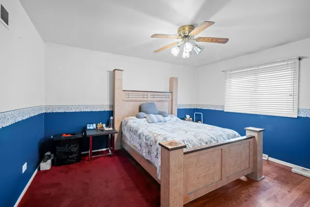 a bed room with a bed and a chandelier