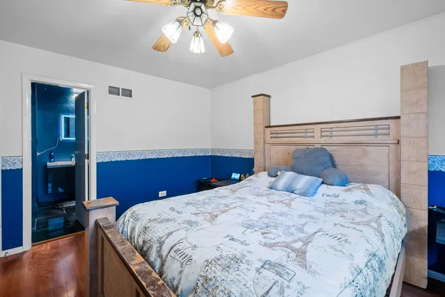 a bedroom with a bed and a chandelier