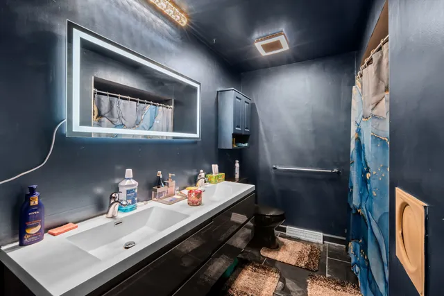 a room with a baby crib and a fireplace