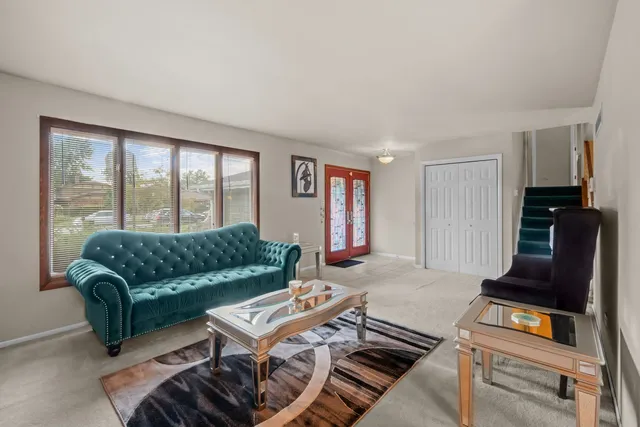 a living room with furniture rug and a window