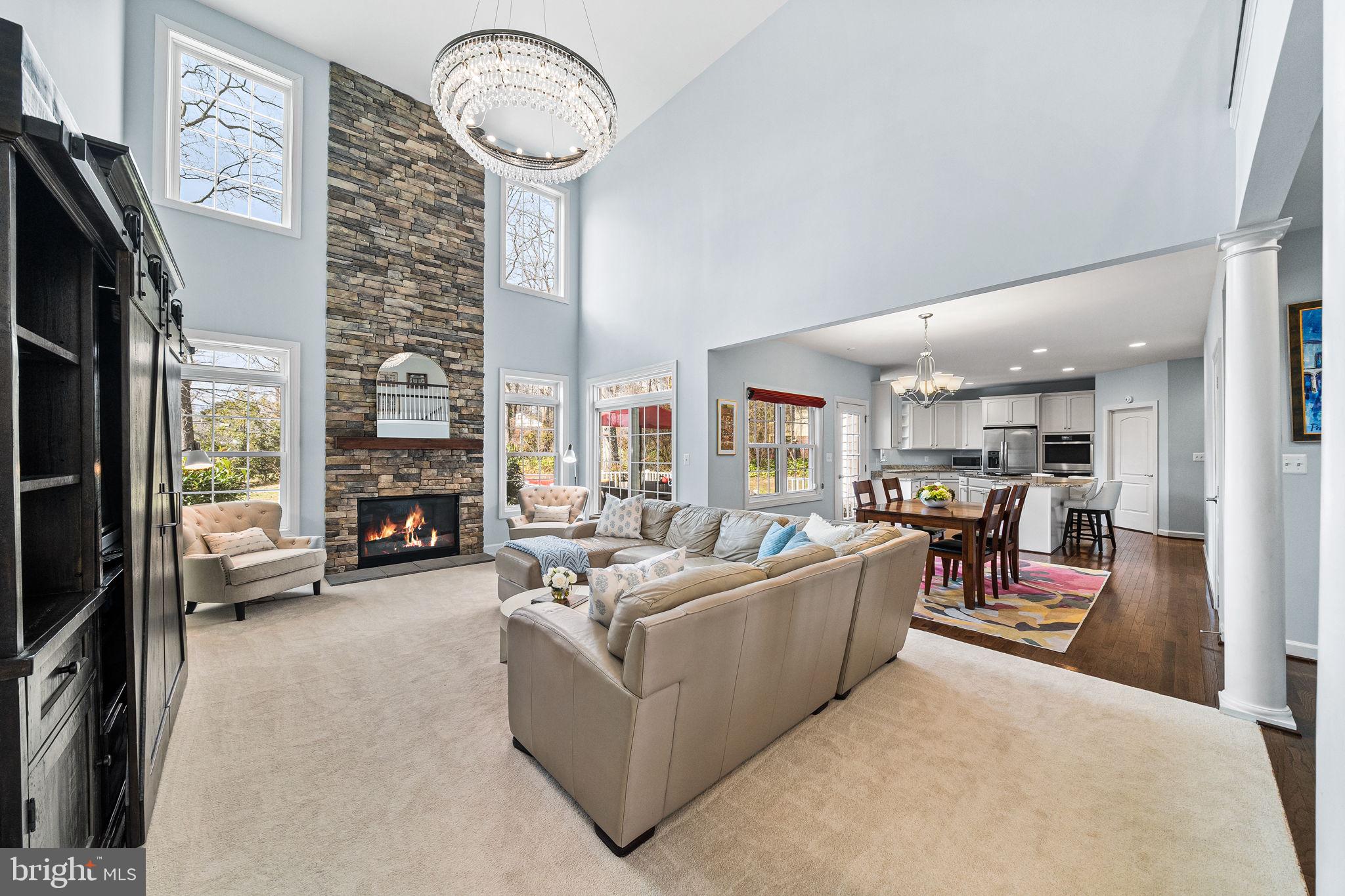 1232 Shenandoah Road Alexandria, VA 22308 - Photo 12 of 50 a living room with furniture a fireplace and a chandelier