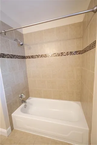a bathroom with a shower and a bath tub
