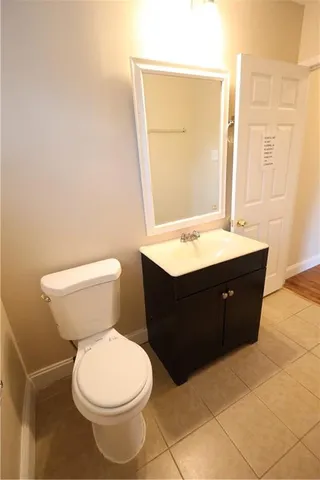 a bathroom with a sink a toilet and mirror