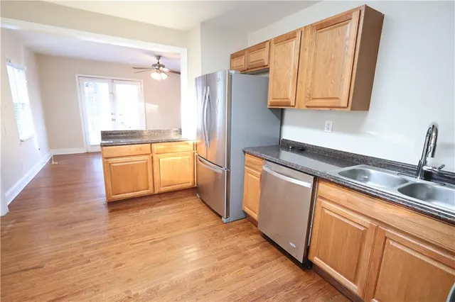 a kitchen with stainless steel appliances granite countertop a refrigerator and a sink