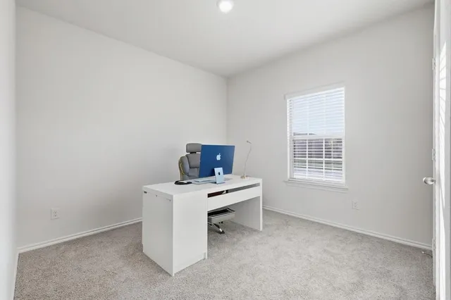 a kitchen with stainless steel appliances a stove top oven a refrigerator a sink and white cabinets with wooden floor