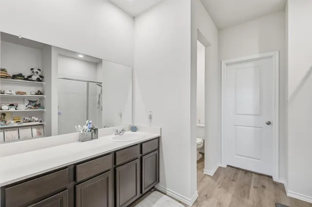 a bathroom with a sink toilet and shower
