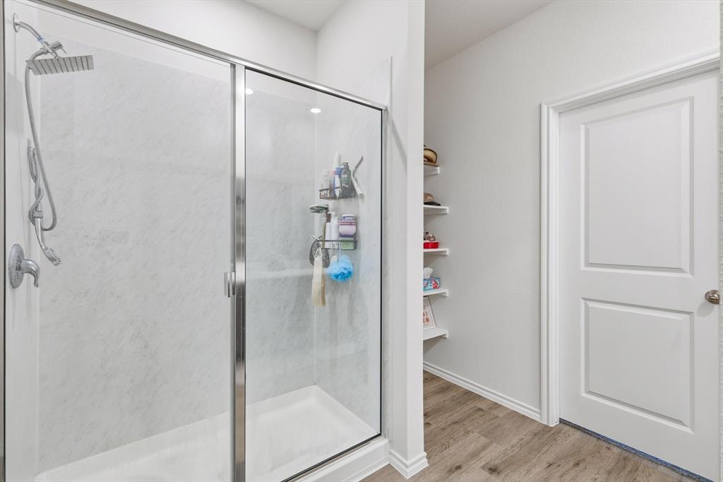 1354 Turkey Run Drive Denton, TX 76207 - Photo 15 of 29 a bathroom with a glass shower door and a glass door