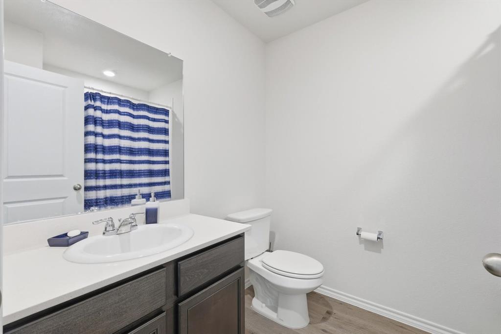 1354 Turkey Run Drive Denton, TX 76207 - Photo 19 of 29 a bathroom with a sink a toilet and mirror