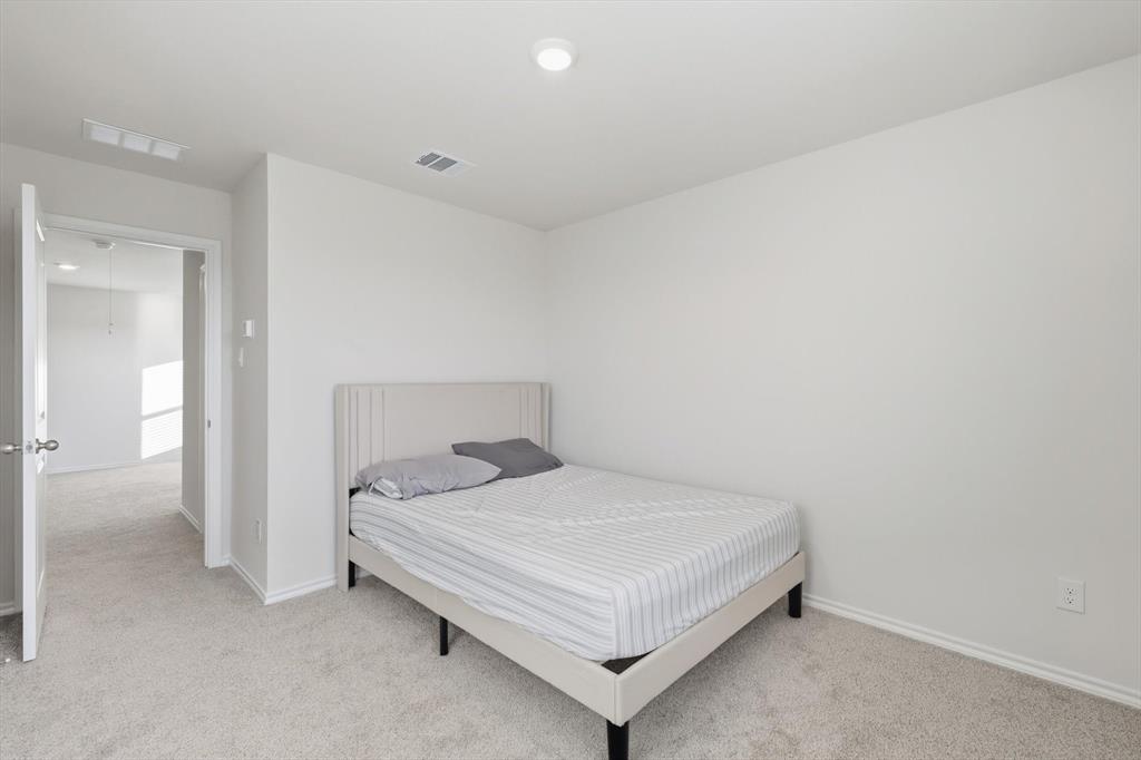 1354 Turkey Run Drive Denton, TX 76207 - Photo 20 of 29 a bedroom with a bed and a table