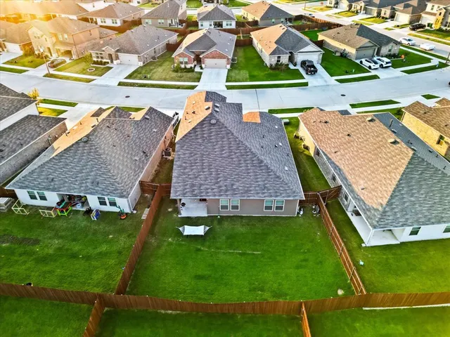an aerial view of residential houses with outdoor space and street view