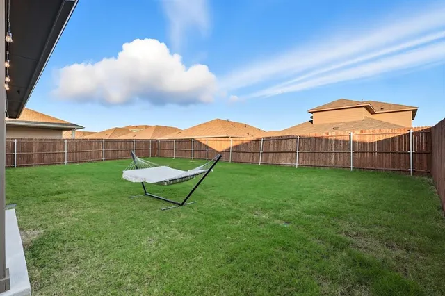 a view of a backyard with a trampoline