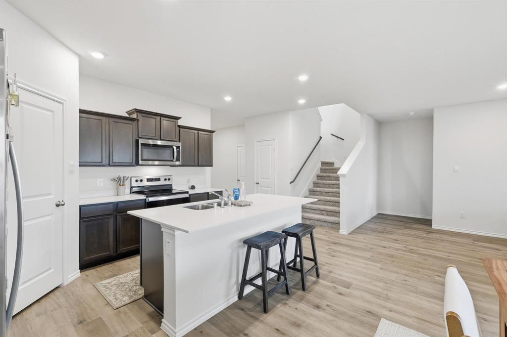 1354 Turkey Run Drive Denton, TX 76207 - Photo 7 of 29 a kitchen with appliances cabinets and wooden floor