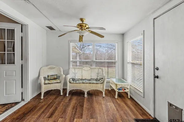 a living room with furniture and wooden floor