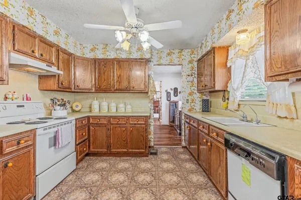 a kitchen with stainless steel appliances granite countertop a refrigerator and a stove