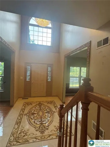 a view of a room with wooden floor and windows