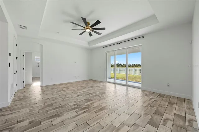 a view of a livingroom with a hardwood floor and a ceiling fan