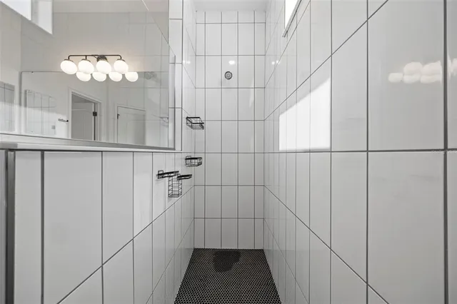 a bathroom with a sink vanity mirror and toilet