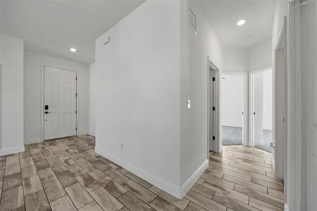 an empty room with a window and a ceiling fan