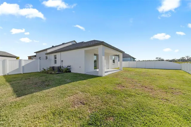 an aerial view of a house with big yard