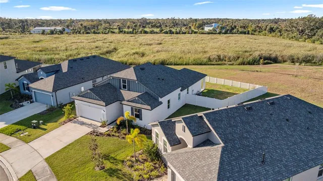 an aerial view of residential houses with outdoor space