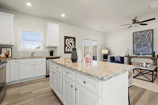 a kitchen with granite countertop cabinets a dining table and chairs