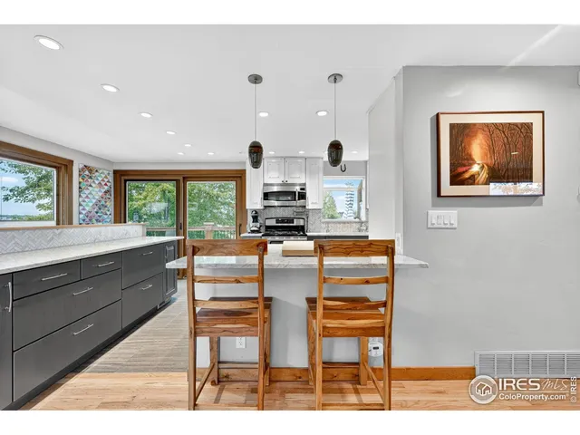 a kitchen with stainless steel appliances kitchen island granite countertop a stove a sink and a microwave