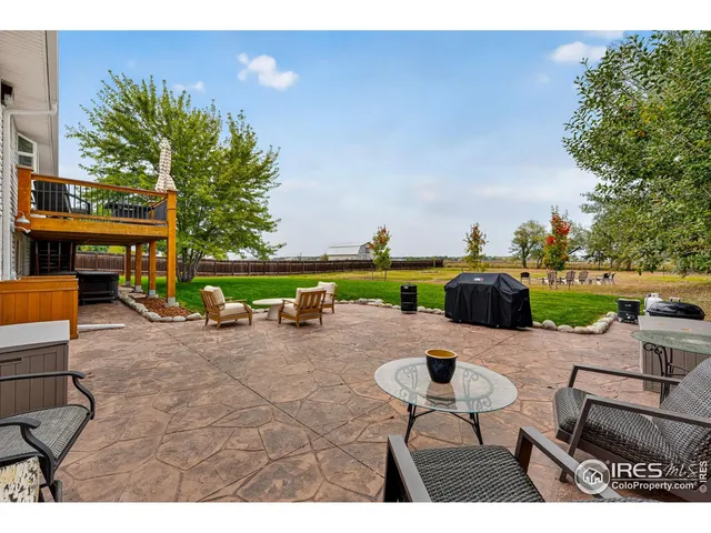 a view of a backyard with table and chairs