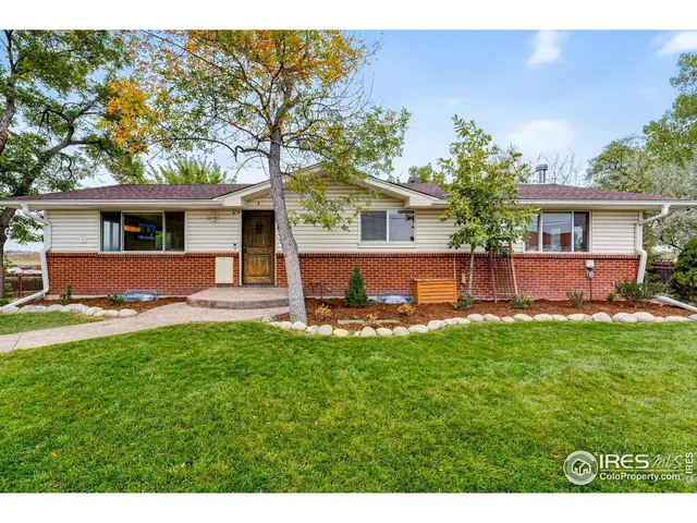 a view of a house with a yard and a garden