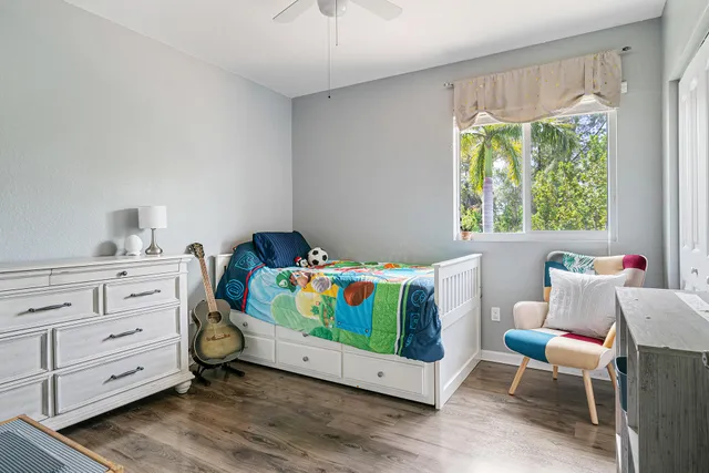 a kitchen with white cabinets and a flat screen tv
