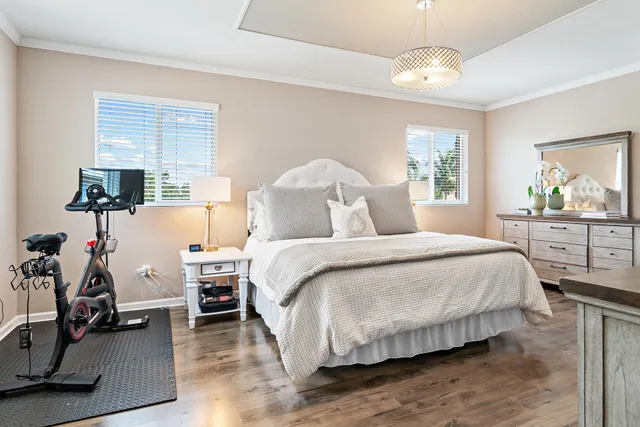 a living room with a flat screen tv and a refrigerator