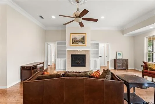 a living room with furniture two window and a fireplace