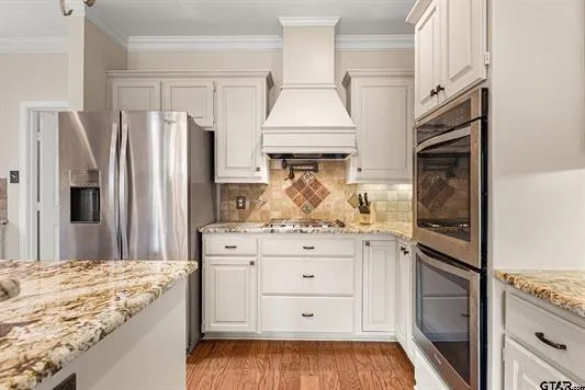 a kitchen with stainless steel appliances a refrigerator sink and cabinets