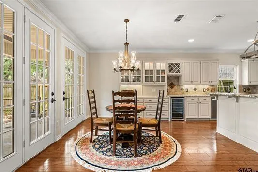 a kitchen with stainless steel appliances kitchen island granite countertop a dining table and chairs