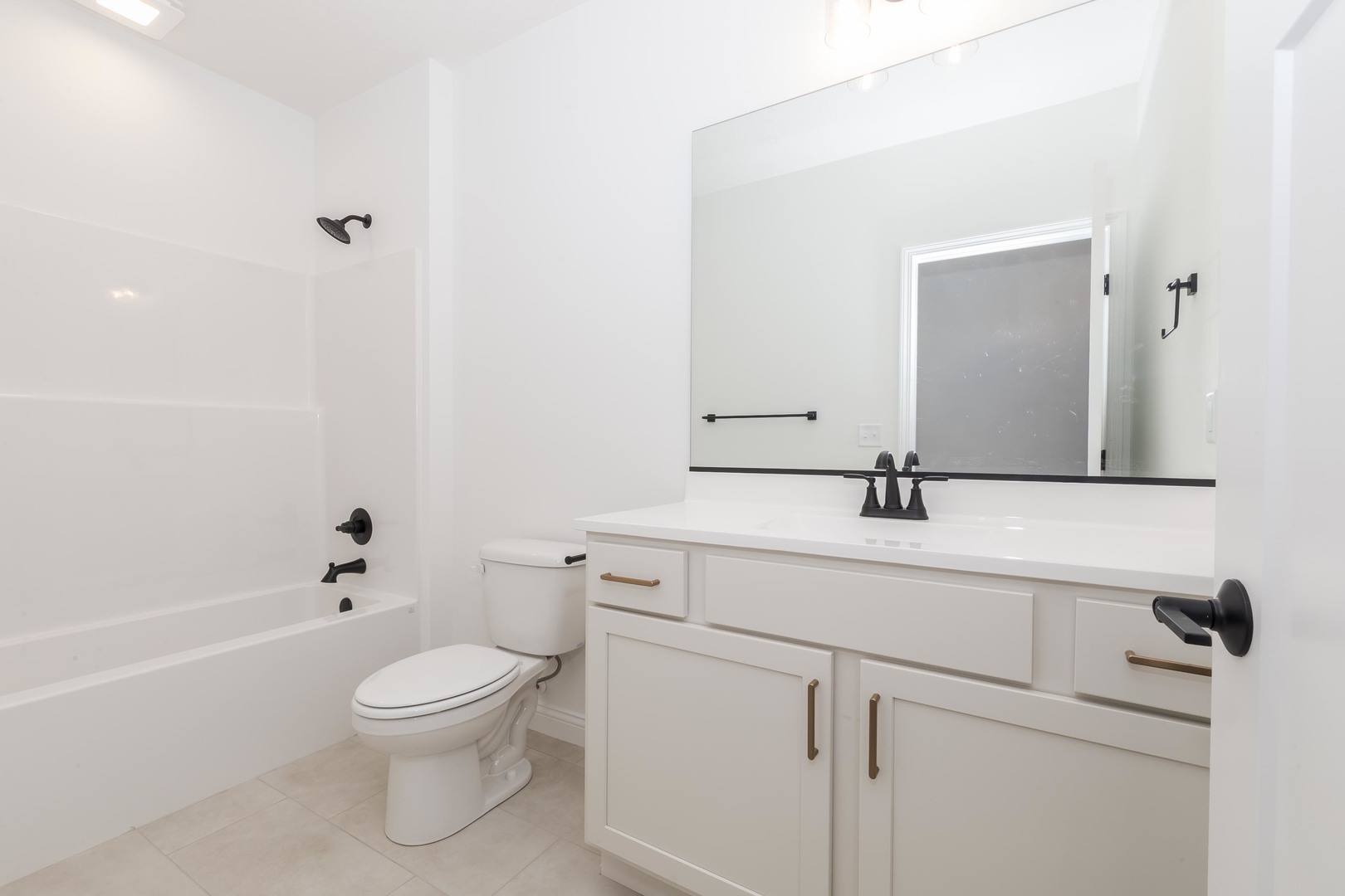 1922 Dunraven Road Bloomington, IL 61704 - Photo 44 of 55 a bathroom with a sink a toilet and shower
