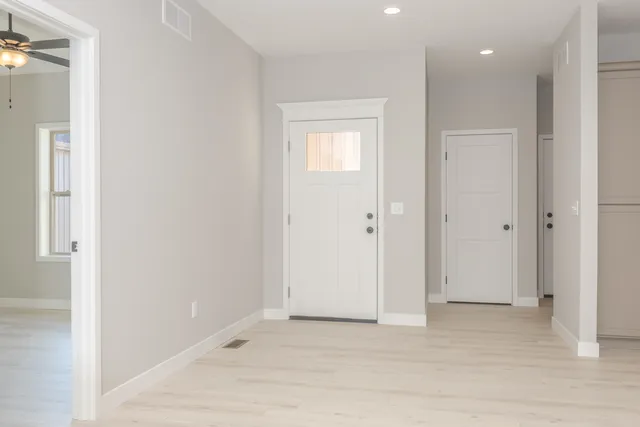 a kitchen with kitchen island white cabinets and sink