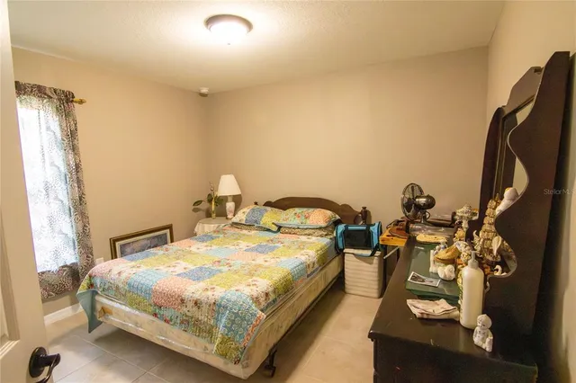 a bed sitting in a bedroom next to a window