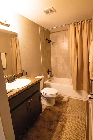 a bathroom with a double vanity sink toilet and shower